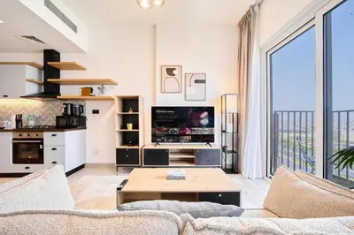 a living room with a couch and a table at Modern 1BR at Collective Dubai Hills Mall Nearby in Dubai