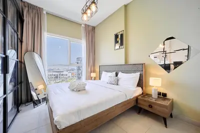 a bedroom with a bed and a large window at Modern 1BR at Collective Dubai Hills Mall Nearby in Dubai