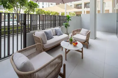 a balcony with chairs and a couch and a table at Frank Porter - Bayshore at Creek Beach Building 4 in Dubai