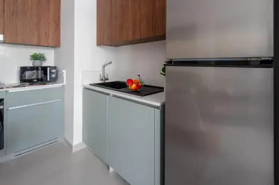 a kitchen with a stainless steel refrigerator and a sink at Frank Porter - Bayshore at Creek Beach Building 4 in Dubai