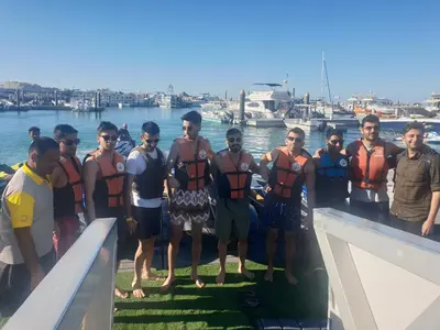 a group of men in life jackets standing on a boat at A one sports jetski rental in Dubai