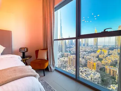 a bedroom with a large window with a city view at Zinnia Luxury 2BHK Bellevue Burj Khalifa View in Dubai