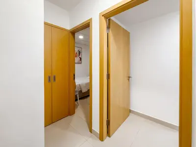 a hallway with a door open to a bedroom at Zinnia Luxury 2BHK Bellevue Burj Khalifa View in Dubai