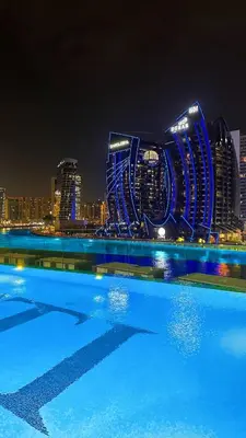 a view of a city skyline at night at Water Dream with Burj Views Sleeps 4 in Dubai