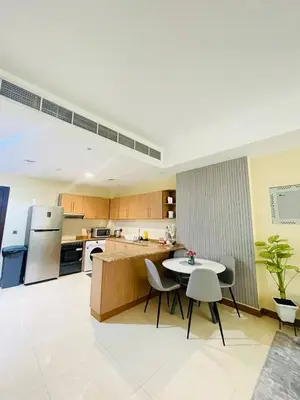 a large kitchen with a table and chairs in it at Luxurious 1 Bedroom Apartment in Heart of Dubai in Dubai