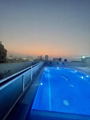 a swimming pool on the roof of a building at Luxurious 1 Bedroom Apartment in Heart of Dubai in Dubai