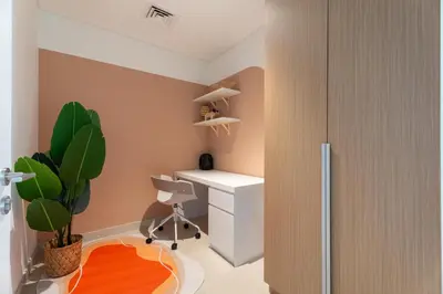 a room with a desk and a chair and a plant at GuestReady - Canal View | 3 Bed | Lagoon Stay in Dubai
