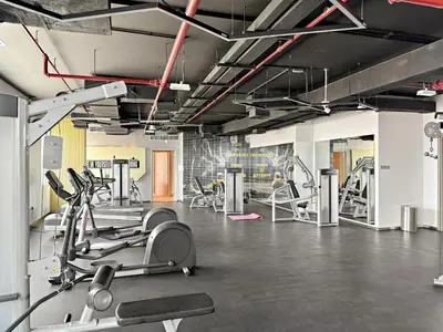 a gym with treadmills and machines in a room at VayK - Prestigious 1BR Apartment in Dubai Hills Estate in Dubai