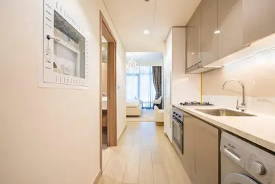 a kitchen with a sink and a counter top at Cozy Studio with a huge terrace in Dubai