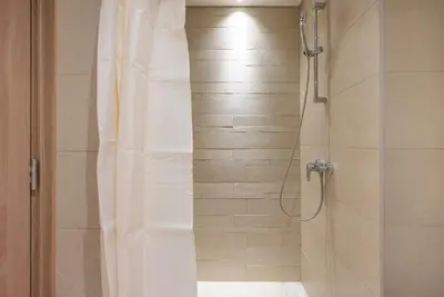 a bathroom with a shower with a shower curtain at Cozy Studio with a huge terrace in Dubai