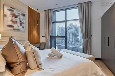 a bedroom with a bed with a large window at Water Front, State of the Art Furniture, Burj View sleeps 4 in Dubai