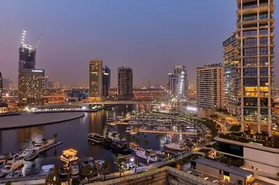 a city skyline at night with a river and buildings at Water Front, State of the Art Furniture, Burj View sleeps 4 in Dubai