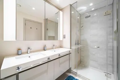 a bathroom with a sink and a shower at SettlerHomes - Sunrise Beach Bliss With Private Beach in Dubai