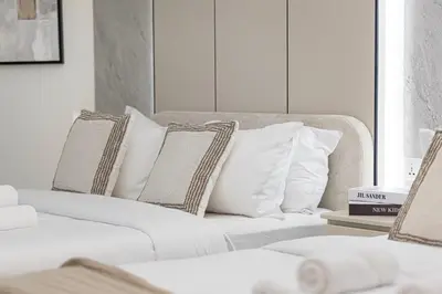 a white couch with pillows in a living room at Charming 3BR Sea View 37th Floor in Dubai