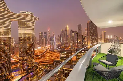 a room with a view of a city at night at Charming 3BR Sea View 37th Floor in Dubai