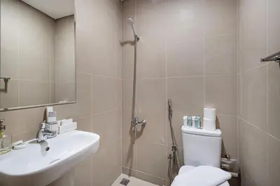 a bathroom with a shower and a toilet and a sink at Charming 3BR Sea View 37th Floor in Dubai