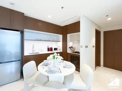 a kitchen with a white table and white chairs at Beachfront 1B at Palm Jumeirah with Balcony & Views in Dubai