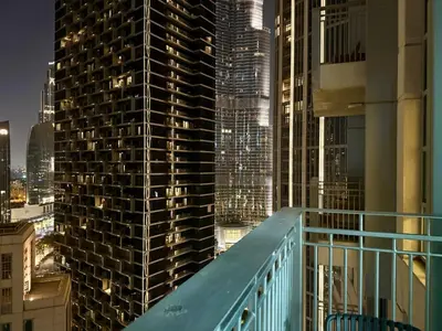 a view from the balcony of a building at night at Urban Retreat 1BR with Pool & Burj Glimpse in Dubai