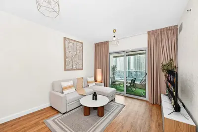 a living room with a couch and a table at Luxury 2BR Marina View-walking distance to JBR beach, marina mall & metro in Dubai
