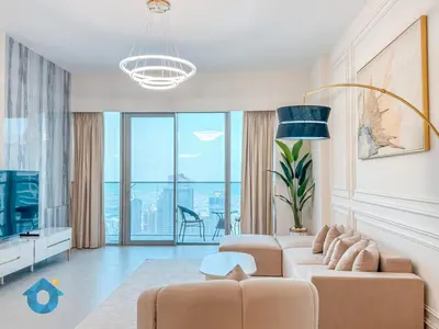 a living room with a couch and a tv at Next to Burj Khalifa & Dubai Mall Luxury 2BR Grande Signature - Like Home in Dubai