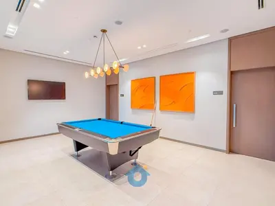a pool table in a room with paintings on the wall at Next to Burj Khalifa & Dubai Mall Luxury 2BR Grande Signature - Like Home in Dubai