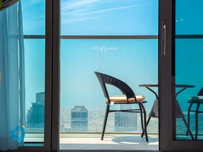 a chair sitting in front of a glass door at Next to Burj Khalifa & Dubai Mall Luxury 2BR Grande Signature - Like Home in Dubai