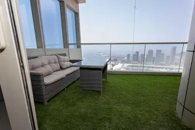 a living room with a couch and a table at Luxuries Sky View Apartment in Dubai