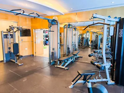 a gym with a bunch of tread machines in it at Luxuries Sky View Apartment in Dubai