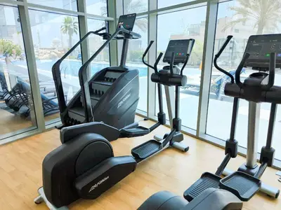 a gym with several exercise bikes in a room at Luxuries Sky View Apartment in Dubai