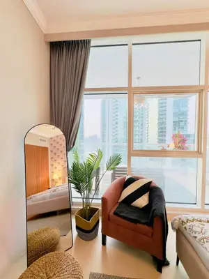 a living room with a chair and a large window at Walk to JBR Marina Beach & Tram! Luxury Family 3BD, Stunning Views in Dubai
