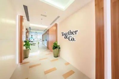 a hallway with plants and a sign on the wall at Hilton Garden inn Dubai Jumeirah in Dubai