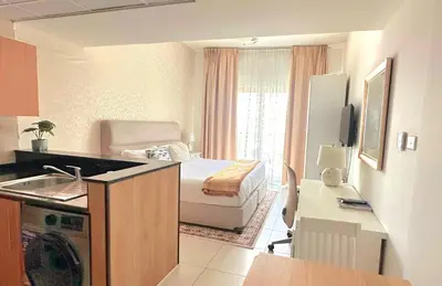 a small room with a kitchen and a bedroom at MARINA VIEWs STUDIO APARTMENT in Dubai