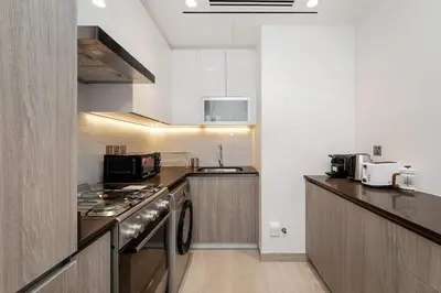 a kitchen with a stove and a counter top at Elegant 1BR Apartment Me Do Re Tower in JLT in Dubai