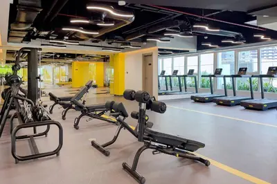 a gym with several treadmills and exercise bikes at Elegant 1BR Apartment Me Do Re Tower in JLT in Dubai
