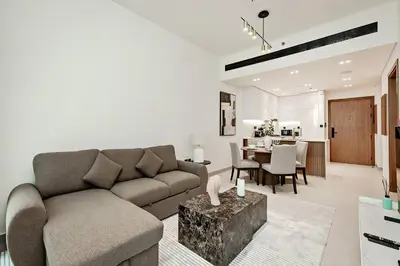 a living room with a couch and a table at Inviting 1BR Apartment in JVC in Dubai