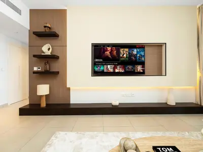 a living room with a flat screen tv on a wall at Modern Jumeirah Apartment Near Beach in Dubai