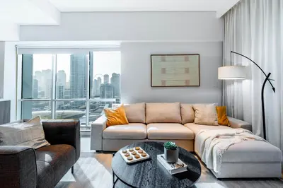 a living room with a couch and a table at Luxury Lakeview Escape in Dubai