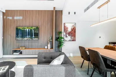 a living room with a table and a dining room at Luxury Lakeview Escape in Dubai