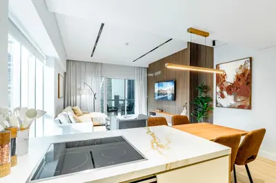 a kitchen and living room with a dining room at Luxury Lakeview Escape in Dubai