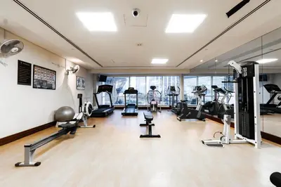 a gym with several treadmills and exercise bikes at Luxury Lakeview Escape in Dubai