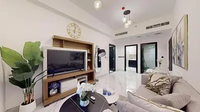 a living room with a couch and a tv at PVH - Spacious 1BR minutes to Miracle Garden in Dubai