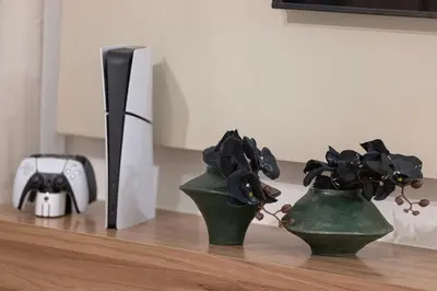 two green vases with flowers in them on a table at Exquisite 2BR Apartment near Dubai Mall, Downtown Dubai in Dubai