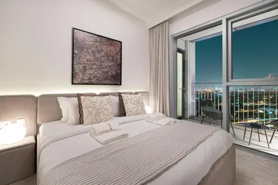 a bedroom with a large bed and a large window at Exquisite 2BR Apartment near Dubai Mall, Downtown Dubai in Dubai
