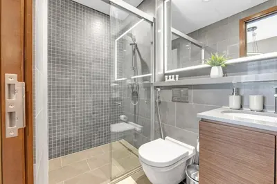 a bathroom with a shower and a toilet and a sink at Classy 2BR Dubai Getaway Near Downtown in Dubai