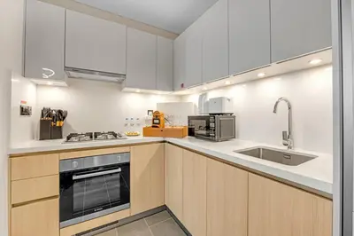 a kitchen with white cabinets and a sink at Classy 2BR Dubai Getaway Near Downtown in Dubai
