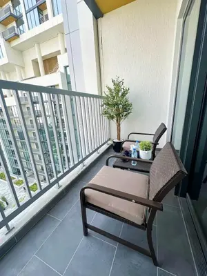 a balcony with a table and a chair on a balcony at Classy 2BR Dubai Getaway Near Downtown in Dubai