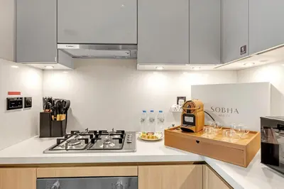 a kitchen with a stove and a counter top at Classy 2BR Dubai Getaway Near Downtown in Dubai