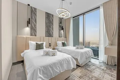 two beds in a room with a large window at Classy 2BR Dubai Getaway Near Downtown in Dubai