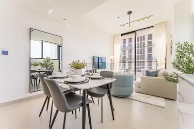 a dining room with a table and chairs at Minutes from Circle Mall, Grocery Stores & Bus Stop 2BR with Mini Private Pool on Balcony, Binghatti Tulip, Jumeirah Village Circle by Deluxe Holiday Homes in Dubai