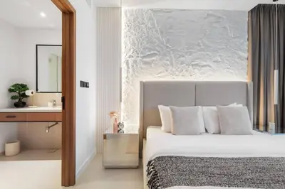 a bedroom with a large bed and a sink at Novity Signature Homes in Dubai